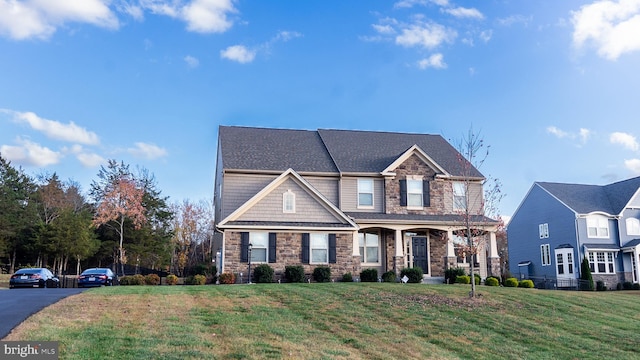 craftsman inspired home with a front lawn and covered porch