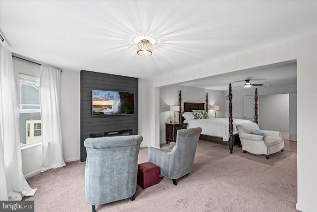 carpeted bedroom featuring multiple windows and a large fireplace