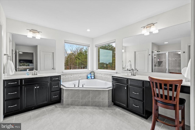 bathroom with shower with separate bathtub, vanity, and tile patterned floors