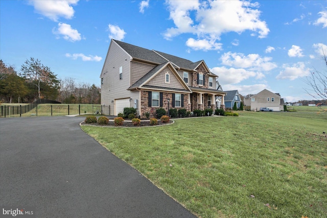 view of front of property featuring a garage and a front lawn