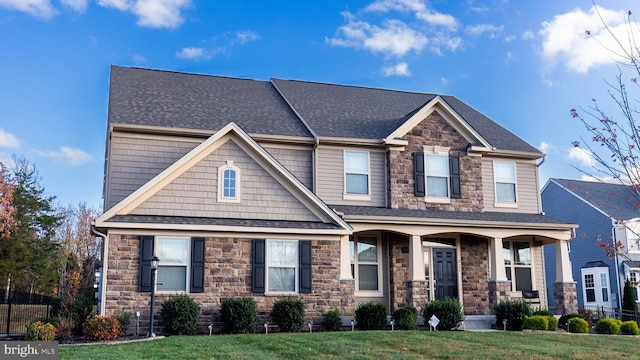 craftsman inspired home with a front yard and a porch