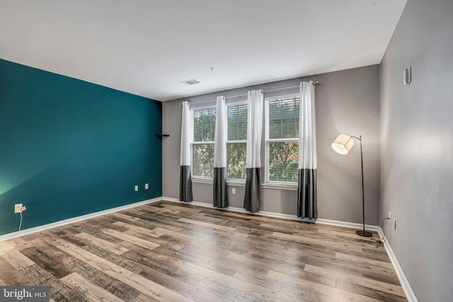 unfurnished room featuring wood-type flooring