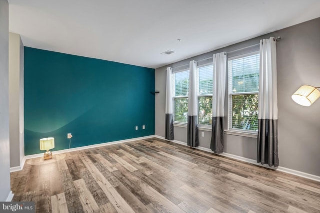 spare room with wood-type flooring