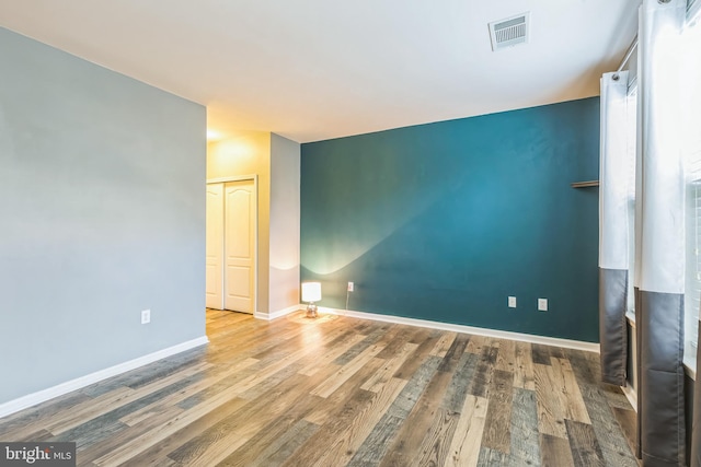 spare room with wood-type flooring