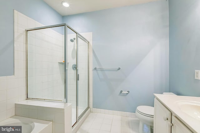 full bathroom with vanity, toilet, plus walk in shower, and tile patterned floors