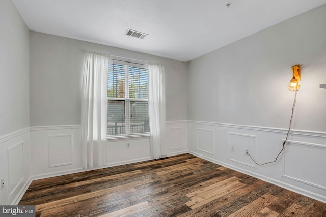 spare room featuring dark hardwood / wood-style floors