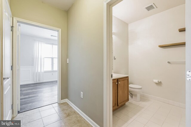 bathroom with vanity, toilet, and wood-type flooring