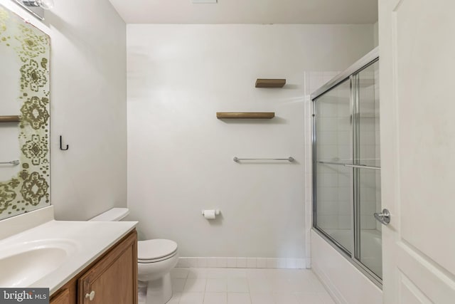 full bathroom featuring tile patterned floors, shower / bath combination with glass door, vanity, and toilet