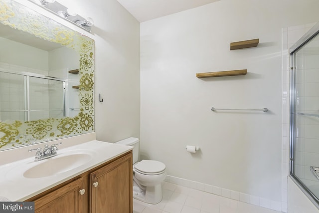 full bathroom with shower / bath combination with glass door, tile patterned floors, vanity, and toilet