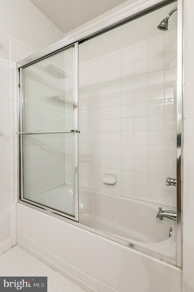 bathroom featuring tile patterned flooring and enclosed tub / shower combo