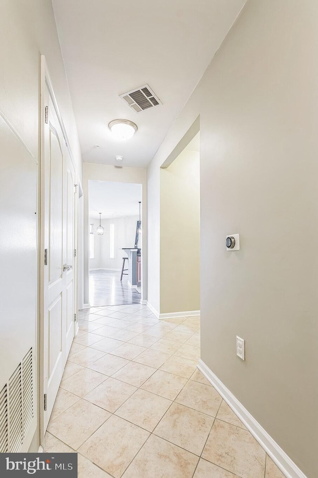 hallway with light tile patterned floors