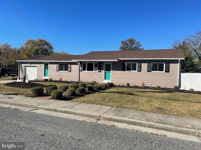 single story home with a garage and a front lawn