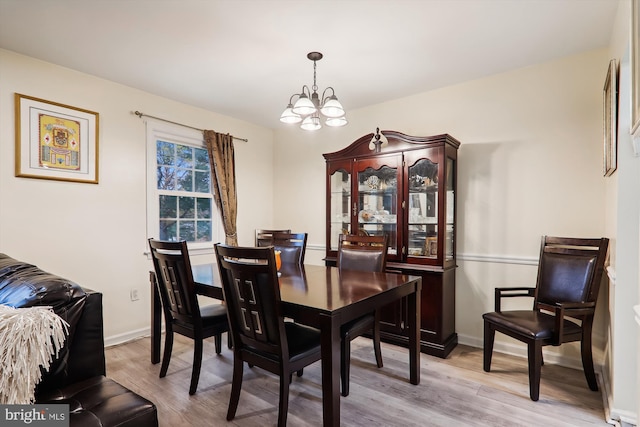 dining room featuring a chandelier and light hardwood / wood-style flooring