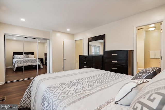 bedroom featuring dark hardwood / wood-style floors and a closet