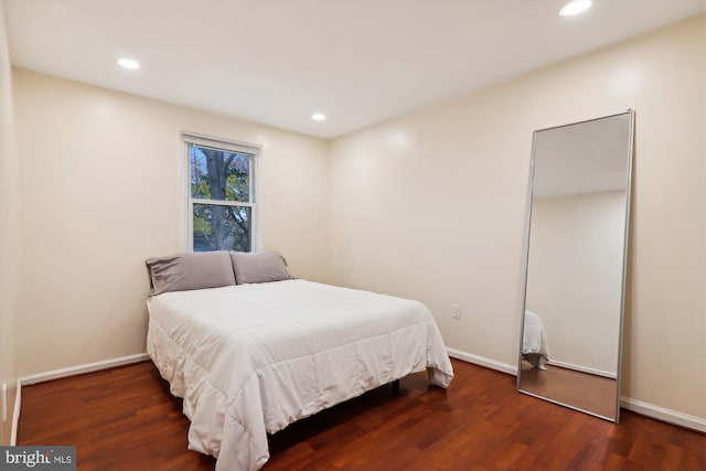 bedroom with dark wood-type flooring