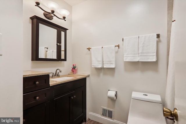 bathroom featuring hardwood / wood-style floors, vanity, and toilet