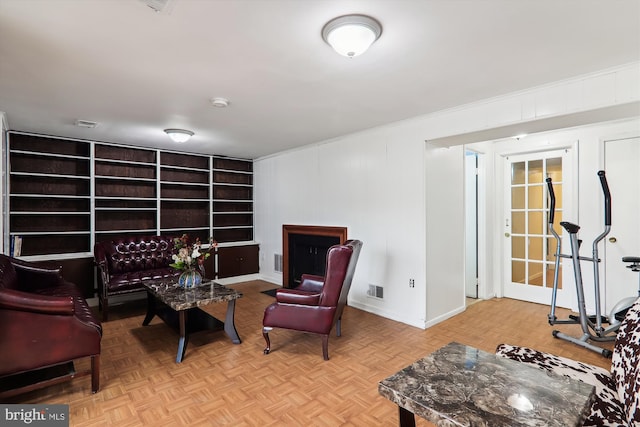 living area featuring ornamental molding and light parquet floors