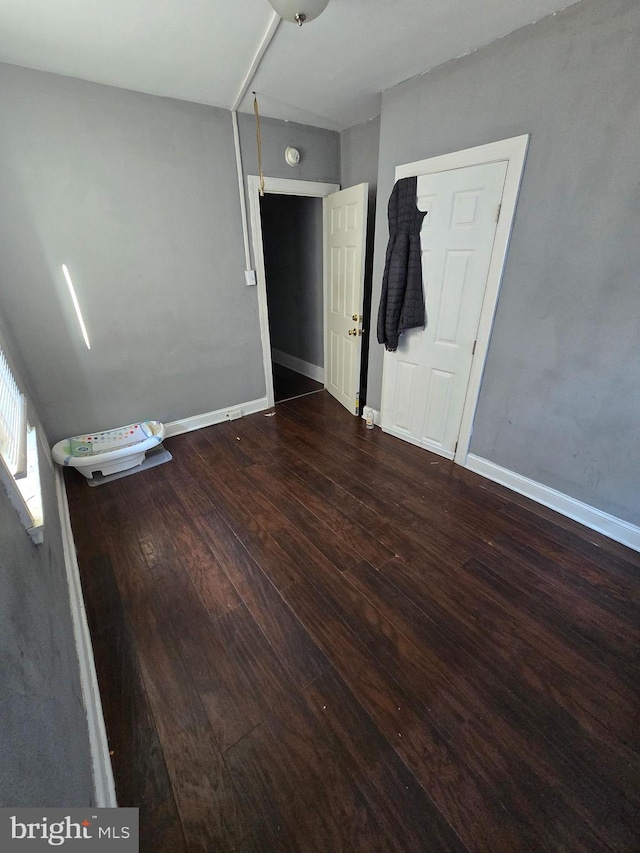 unfurnished bedroom featuring dark hardwood / wood-style floors