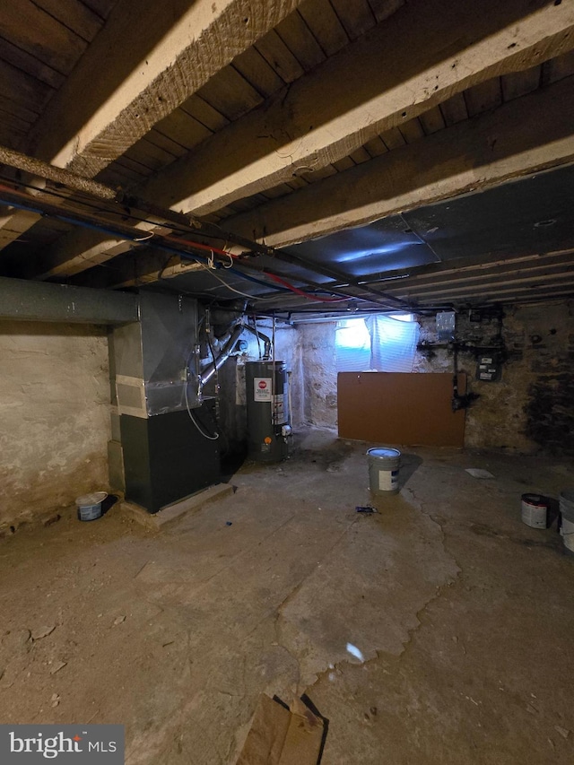 basement featuring gas water heater and heating unit