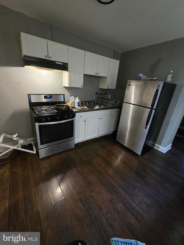 kitchen with dark hardwood / wood-style floors, sink, white cabinetry, and stainless steel appliances