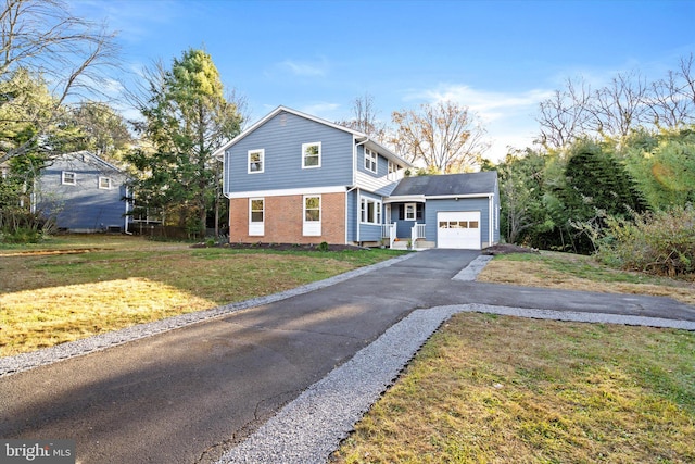 view of front of home with a front lawn and a garage