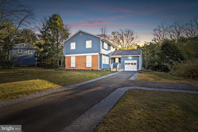 view of front of house featuring a lawn and a garage