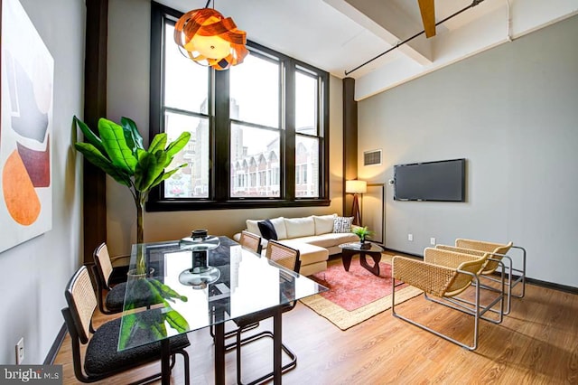 living room featuring hardwood / wood-style flooring and beam ceiling