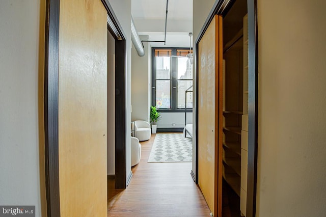 hallway with light hardwood / wood-style flooring