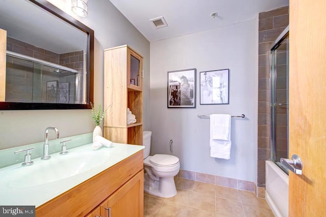 full bathroom with toilet, vanity, tile patterned flooring, and enclosed tub / shower combo