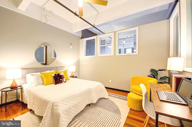 bedroom with ceiling fan and wood-type flooring