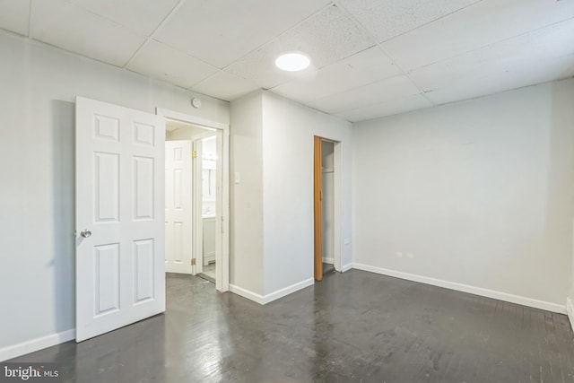 unfurnished room with a drop ceiling