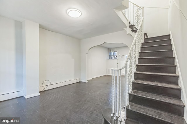 staircase featuring a baseboard radiator