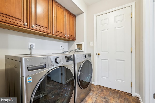 laundry area with washer and clothes dryer and cabinets