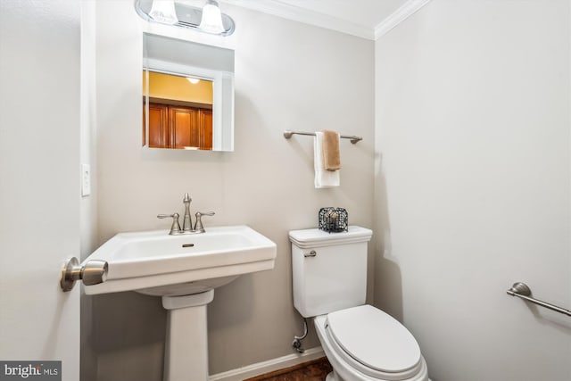 bathroom with ornamental molding and toilet