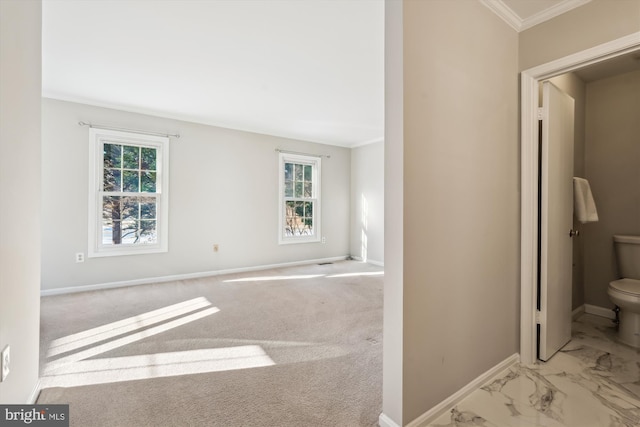 interior space featuring toilet and ornamental molding