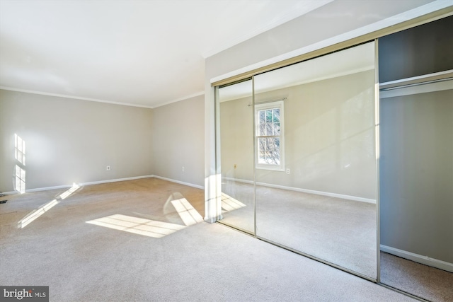 unfurnished bedroom featuring ornamental molding and carpet floors