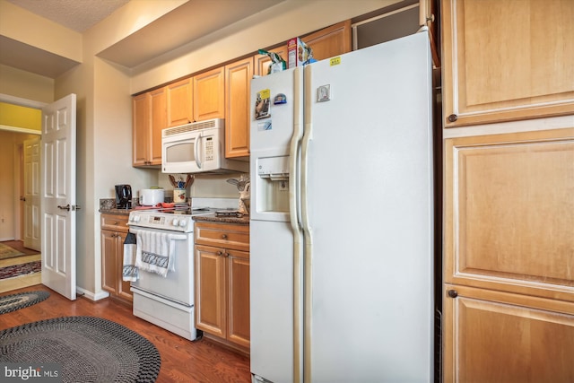 kitchen featuring a textured ceiling, light brown cabinetry, dark hardwood / wood-style floors, and white appliances