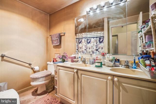 bathroom featuring toilet, vanity, and walk in shower