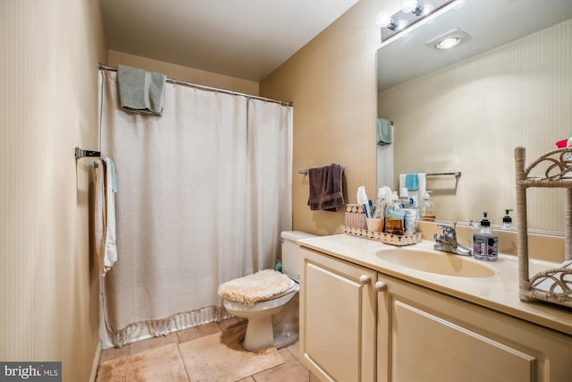 bathroom with toilet, vanity, a shower with shower curtain, and tile patterned flooring