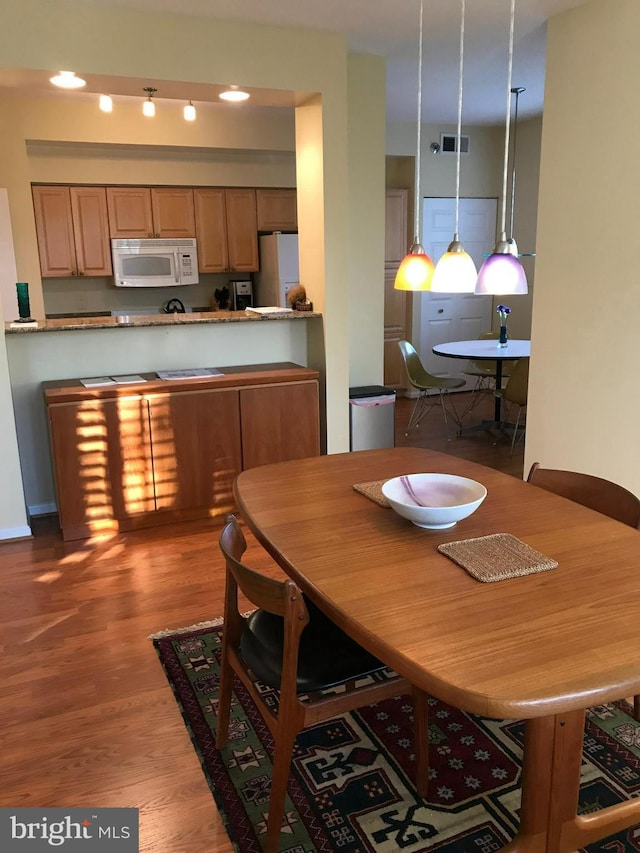 dining room featuring wood-type flooring