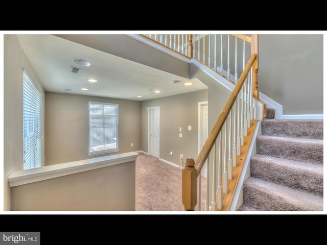 stairs featuring carpet