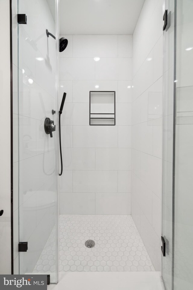 bathroom with a shower with door