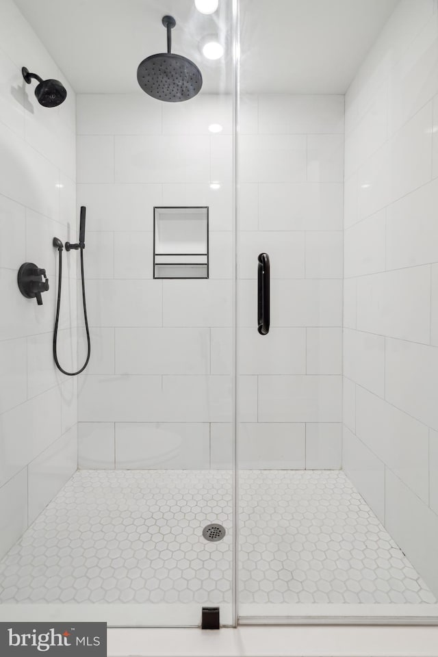 bathroom with a shower with shower door