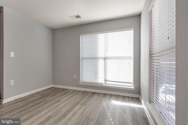 spare room featuring light hardwood / wood-style floors