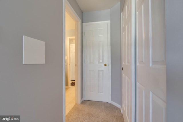 corridor with light colored carpet