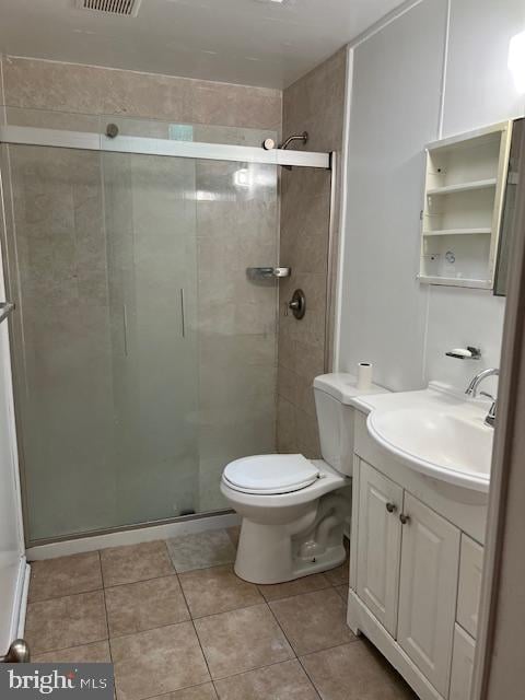 bathroom featuring toilet, an enclosed shower, vanity, and tile patterned floors