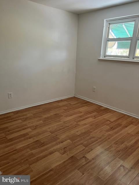 empty room with hardwood / wood-style floors