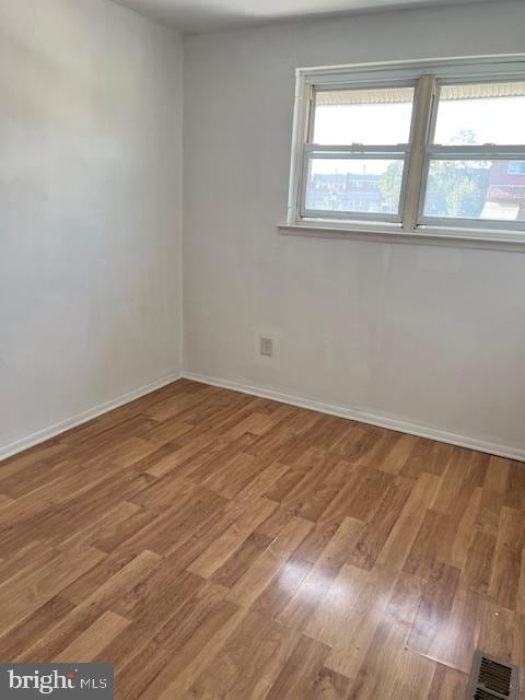 spare room featuring hardwood / wood-style floors