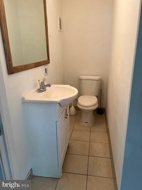 bathroom featuring vanity, tile patterned floors, and toilet