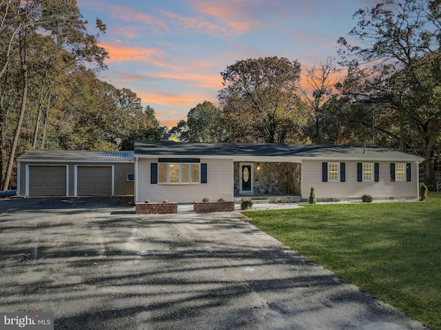 view of front of home featuring a lawn and a garage